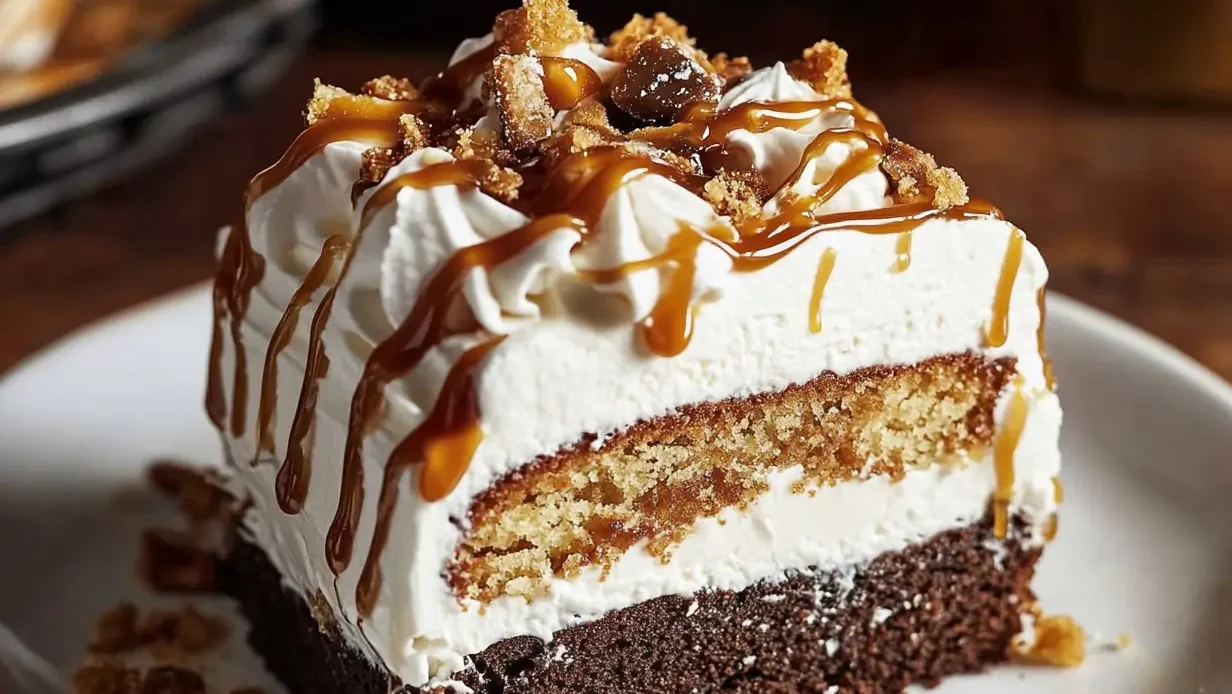 A slice of Better Than Sex Cake topped with caramel and toffee.