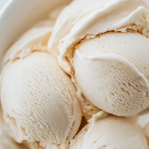 Scoops of creamy vanilla ice cream served in a bowl – easy no-churn recipe